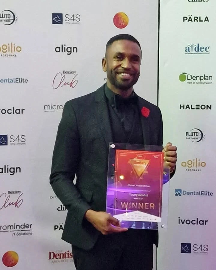 Dr Ahmed Abdelrahman holding his Young Dentist award